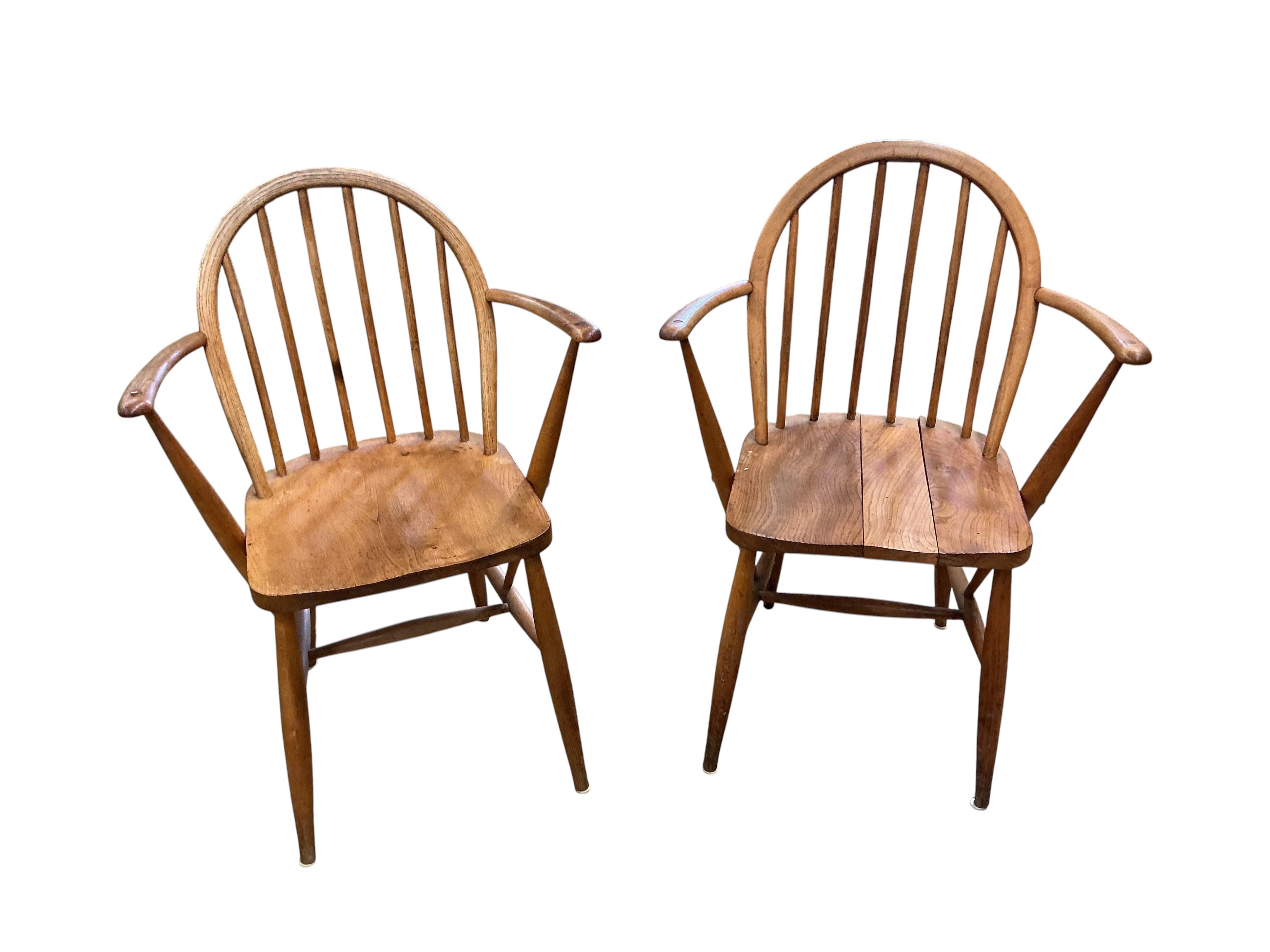 A pair of Ercol elm and beech comb back Windsor elbow chairs, width 60cm, depth 40cm, height 86cm